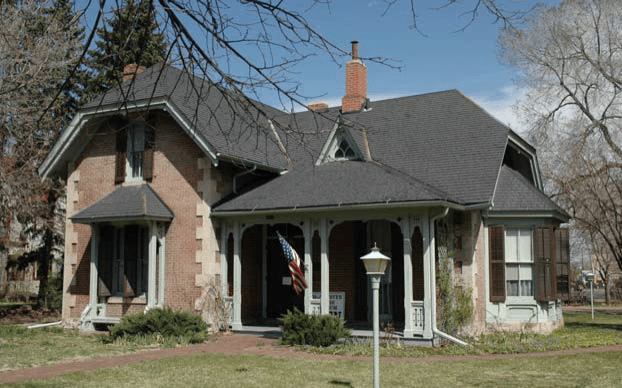 Historic McAllister House with a grand porch and flag flying high. Built in 1873 by architect George Summers. 423 N Cascade Ave.