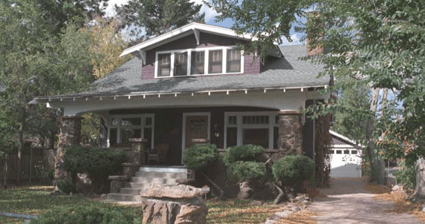 A charming house with a spacious front porch and a stone walkway, nestled at 12 West St. Vrain Street. Built in 1922, its architect remains a mystery.