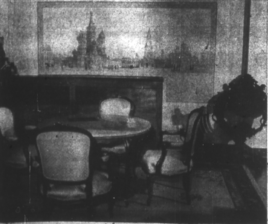 Newspaper image: One corner of the salon could be called a game room, having an inlaid marble card table by F. Martelli of Florence, Italy. The four chairs are Louis XV and the Italian antique chair at right is identical with the original which is in the Vatican. The mural is a sketch of the old Kremlin and St. Basil's Cathedral, by Mr. Lefkowsky.