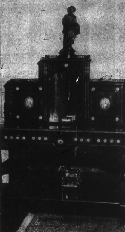 Newspaper image: The Louis XVI writing desk from the A. Petrone collection, Paris, France, is of ebony wood tuja wood and palissandre wood, decorated with Se'vres porcelain plaques and gilt bronzes.